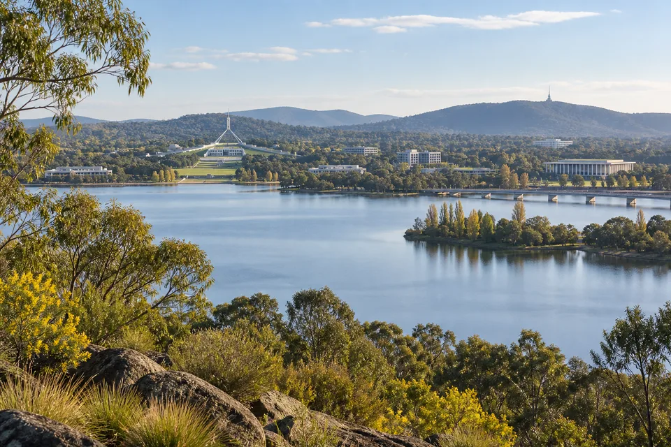 Generated editorial illustration of Canberra's lake and civic landscape.